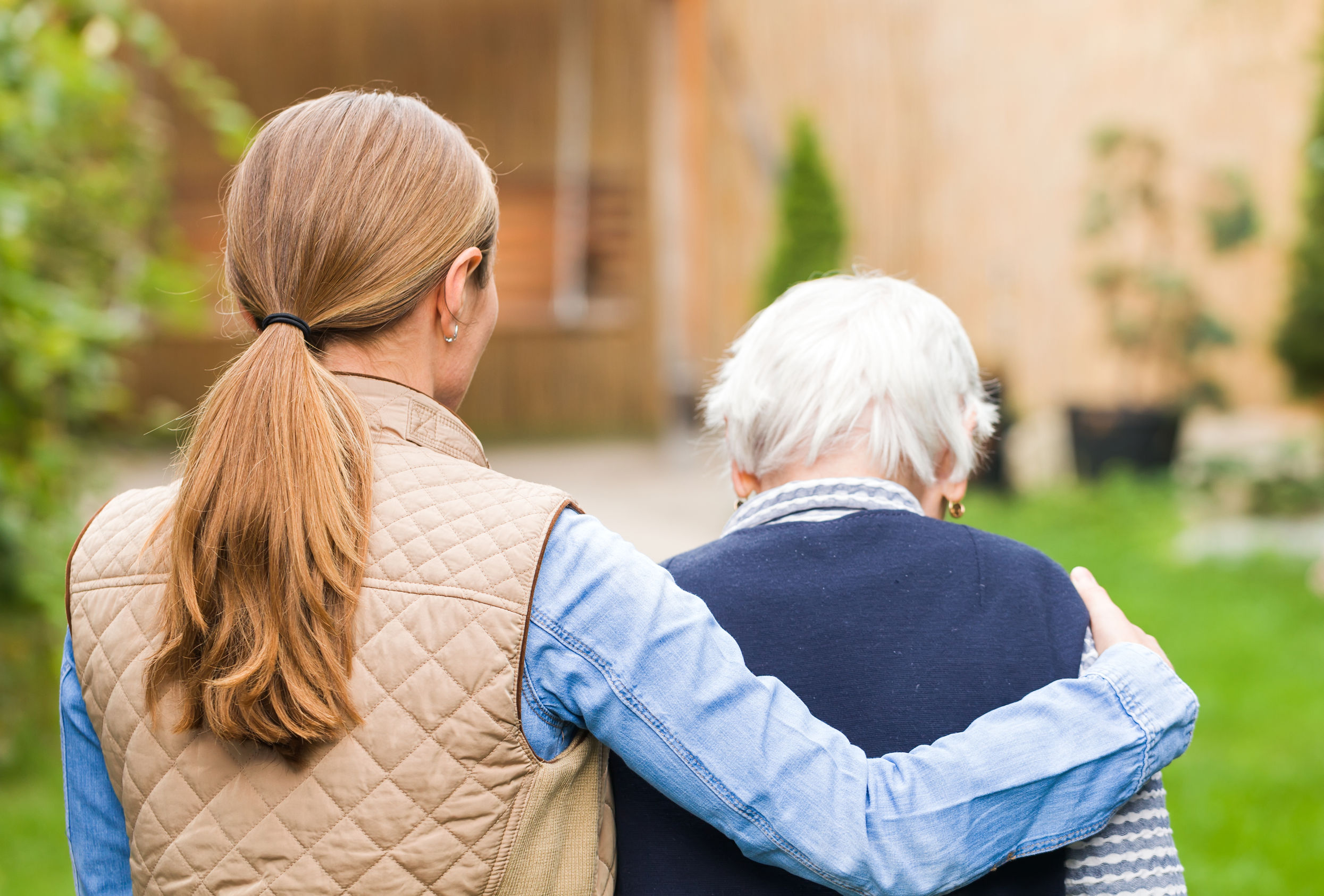 Young woman helping elderly woman to her house Young woman helping elderly woman to her house